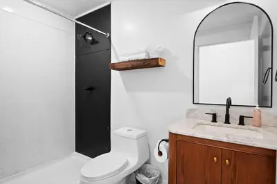 a bathroom with a toilet and a sink and a mirror at Summit Haus Cozy Getaway in the Poconos in Pocono Summit