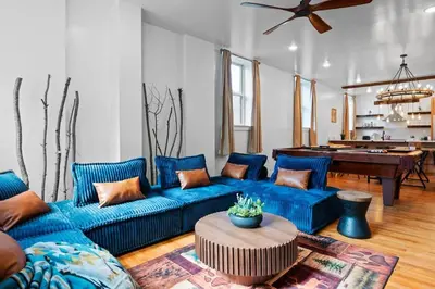 a living room with a blue couch and a table at Summit Haus Cozy Getaway in the Poconos in Pocono Summit