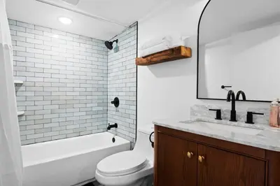 a white bathroom with a toilet and a sink at Summit Woods Hideaway Cozy Pocono Getaway in Pocono Summit