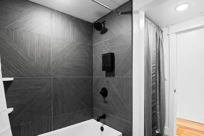a bathroom with a shower and a white bath tub at Summit Woods Hideaway Cozy Pocono Getaway in Pocono Summit