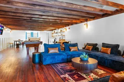 a living room with blue couches and a pool table at Lakeside Serenity Retreat Near Kalahari Resort in Pocono Summit