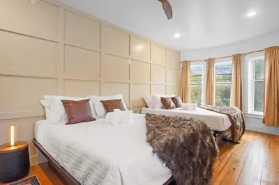 a bedroom with two beds and a large window at Lakeside Serenity Retreat Near Kalahari Resort in Pocono Summit