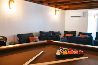 a ping pong table in a room with chairs at Lakeside Serenity Retreat Near Kalahari Resort in Pocono Summit