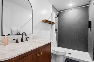 a bathroom with a sink and a toilet and a shower at Lakeside Serenity Retreat Near Kalahari Resort in Pocono Summit