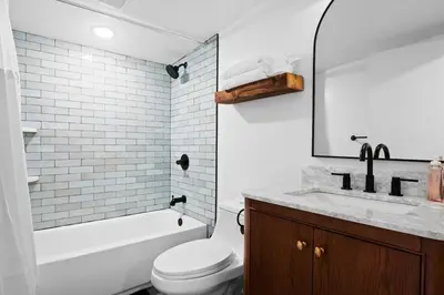 a white bathroom with a toilet and a sink at Modern Mountain Escape Sleeps Large Groups in Pocono Summit