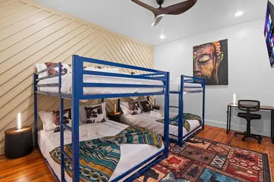 a room with two bunk beds and a table at Modern Mountain Escape Sleeps Large Groups in Pocono Summit