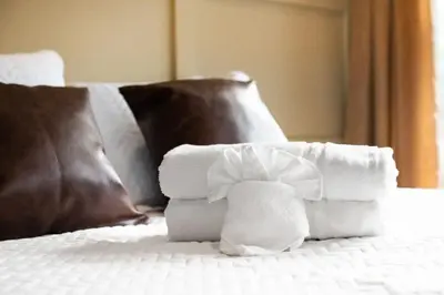 a pile of towels sitting on top of a bed at Modern Mountain Escape Sleeps Large Groups in Pocono Summit