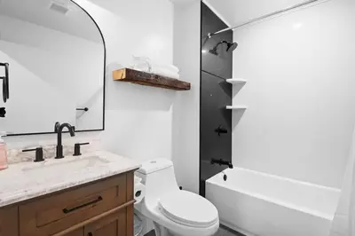 a bathroom with a toilet and a sink and a mirror at Pocono Summit Lodge Game Room & Family Fun in Pocono Summit