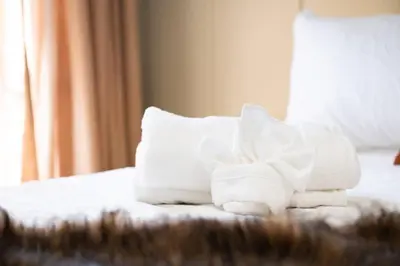 a pile of towels sitting on top of a bed at Pocono Summit Lodge Game Room & Family Fun in Pocono Summit