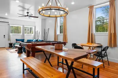 a living room with a table and a ping pong table at Pocono Summit Lodge Game Room & Family Fun in Pocono Summit