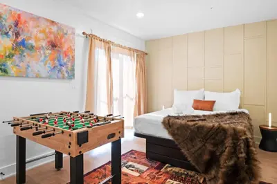 a bedroom with a bed and a chess board on a table at The Grand Pocono Getaway Waterparks & Raceway in Pocono Summit