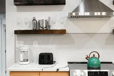 a kitchen with a counter with glasses on the wall at The Grand Pocono Getaway Waterparks & Raceway in Pocono Summit