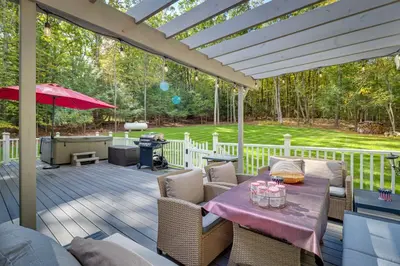 a patio with a table and chairs and an umbrella at Hot Tub and Game Room Retreat Near Camelback in Reeders
