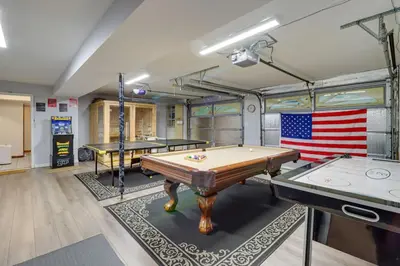 a billiard room with two tables and an american flag at Hot Tub and Game Room Retreat Near Camelback in Reeders