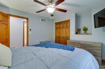 a bedroom with a bed with a ceiling fan at Hot Tub and Game Room Retreat Near Camelback in Reeders