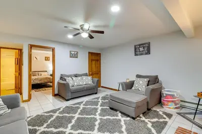 a living room with two couches and a ceiling fan at Hot Tub and Game Room Retreat Near Camelback in Reeders