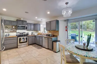 a kitchen with a table and a dining room at Hot Tub and Game Room Retreat Near Camelback in Reeders