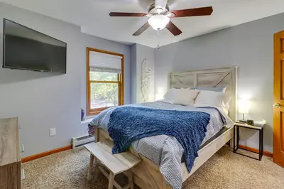 a bedroom with a bed and a ceiling fan at Hot Tub and Game Room Retreat Near Camelback in Reeders