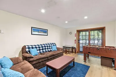 a living room with a couch and a pool table at Pocono's Resort | Fire Pit, Jacuzzi, Winter Sport in Lake Ariel