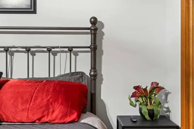 a red pillow and a vase of flowers on a table at Pocono's Resort | Fire Pit, Jacuzzi, Winter Sport in Lake Ariel