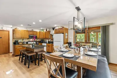 a kitchen and dining room with a table and chairs at Pocono's Resort | Fire Pit, Jacuzzi, Winter Sport in Lake Ariel