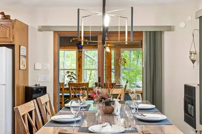 a dining room with a long table with chairs at Pocono's Resort | Fire Pit, Jacuzzi, Winter Sport in Lake Ariel