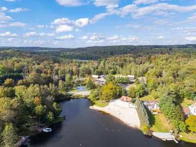 an aerial view of a house and a river at Pocono's Resort | Fire Pit, Jacuzzi, Winter Sport in Lake Ariel