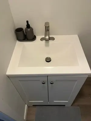 a white sink in a kitchen with at Cozy guest room 20mins to city in North Bergen