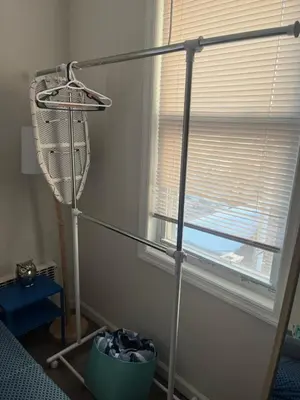 a fan in a room next to a window at Cozy guest room 20mins to city in North Bergen
