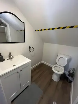 a bathroom with a sink and a toilet and a mirror at Cozy guest room 20mins to city in North Bergen