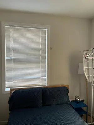 a bedroom with a bed and a large window at Cozy guest room 20mins to city in North Bergen