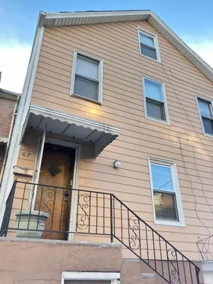 a house with a door and a balcony at Quite and Sweet guest room near nyc in Guttenberg