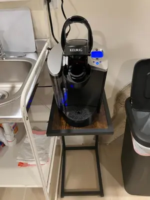 a coffee maker sitting on a table next to a sink at Comfort guest room near everything in Guttenberg