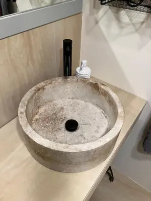 a stone sink on a counter in a bathroom at Comfort guest room near everything in Guttenberg