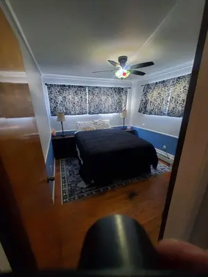 a bedroom with a bed and a ceiling fan at Sunset Over The Junction in Roscoe
