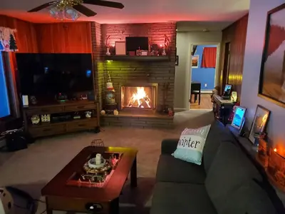 a living room with a couch and a fireplace at Sunset Over The Junction in Roscoe
