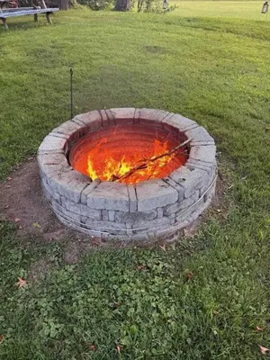 a fire pit in the grass in a field at Sunset Over The Junction in Roscoe