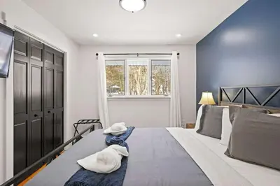 a bedroom with a large bed with towels on it at North Shore Lodge - 5000SqFt Game Area Hot Tub in Jonas