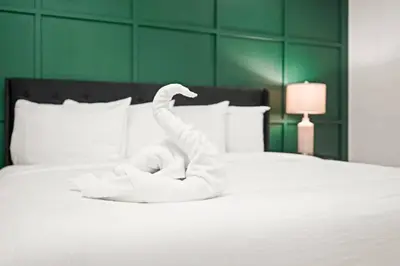 a white swan made out of towels on a bed at North Shore Lodge - 5000SqFt Game Area Hot Tub in Jonas