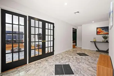 an empty living room with sliding glass doors at North Shore Lodge - 5000SqFt Game Area Hot Tub in Jonas