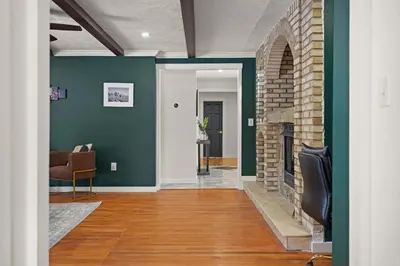 a living room with green walls and a fireplace at North Shore Lodge - 5000SqFt Game Area Hot Tub in Jonas