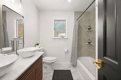 a bathroom with a sink and a toilet and a shower at North Shore Lodge - 5000SqFt Game Area Hot Tub in Jonas