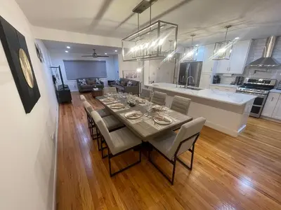 a dining room and kitchen with a table and chairs at Modern Glam Getaway 30 minutes from NYC in West Orange
