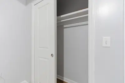 a room with a closet with white walls at Cozy 2BR Apartment in Jersey City with Smart Lock in Croxton