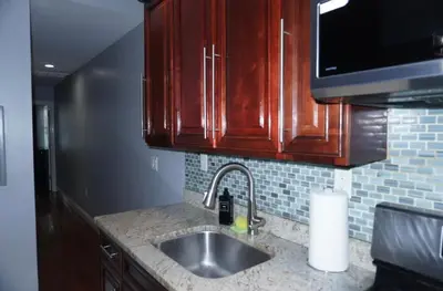 a kitchen with a sink and a microwave at New York Private Room 32 in West New York