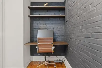 a desk in a room with a brick wall at Charming Retreat in Trendy NoLibs in Philadelphia
