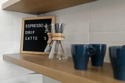 a kitchen counter with a chalkboard sign and blue cups at Charming Retreat in Trendy NoLibs in Philadelphia