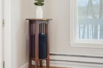 a wooden table in a room next to a window at The Waters Edge Escape in East Stroudsburg