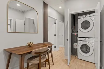 a laundry room with a table and a washer and dryer at Apartmint at The Metropolitan1 - Philadelphia in Philadelphia