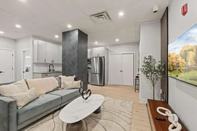 a living room with a couch and a kitchen at Apartmint at The Metropolitan1 - Philadelphia in Philadelphia